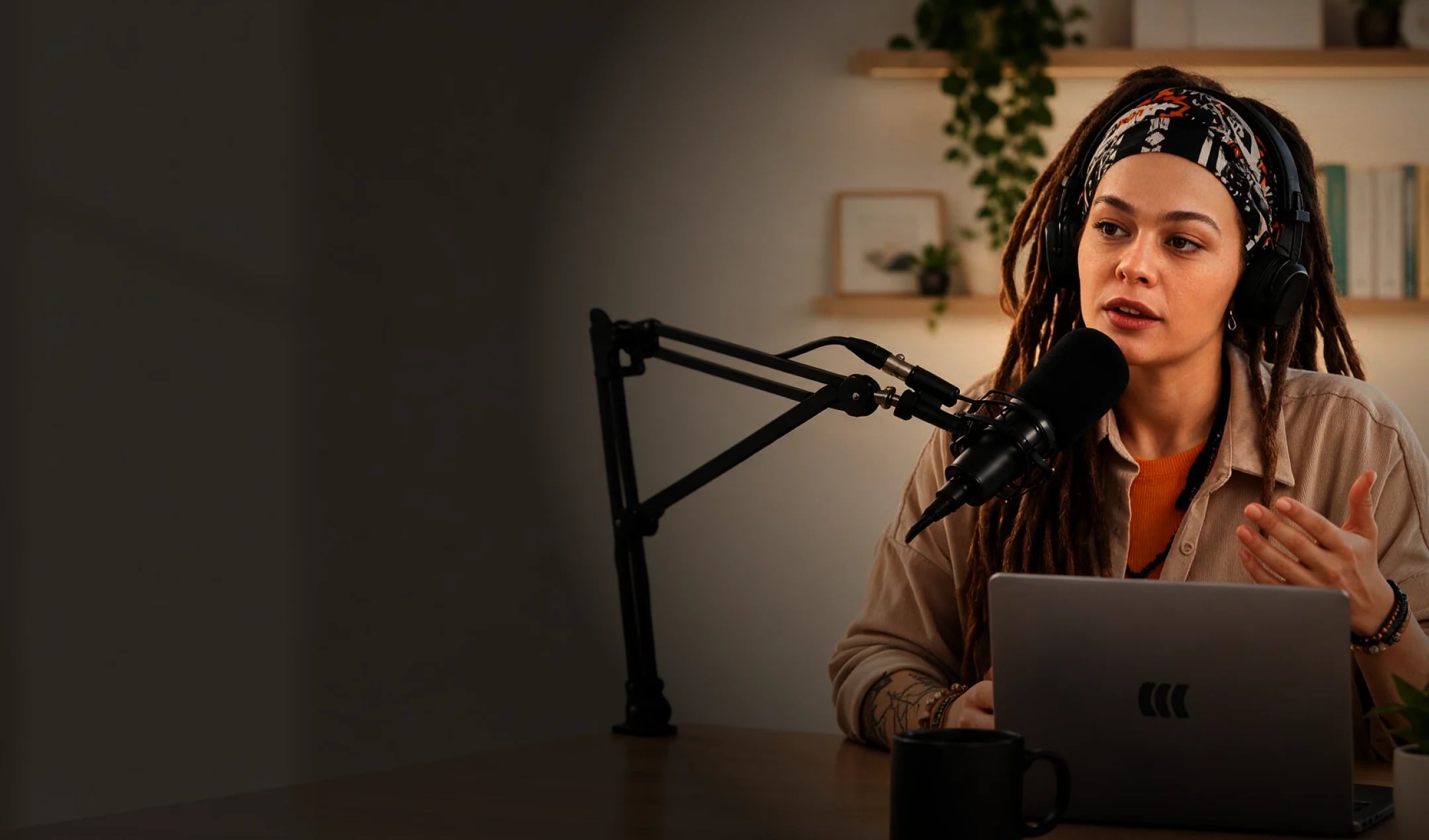 Presenter recording a webinar at her desk with a microphone and laptop