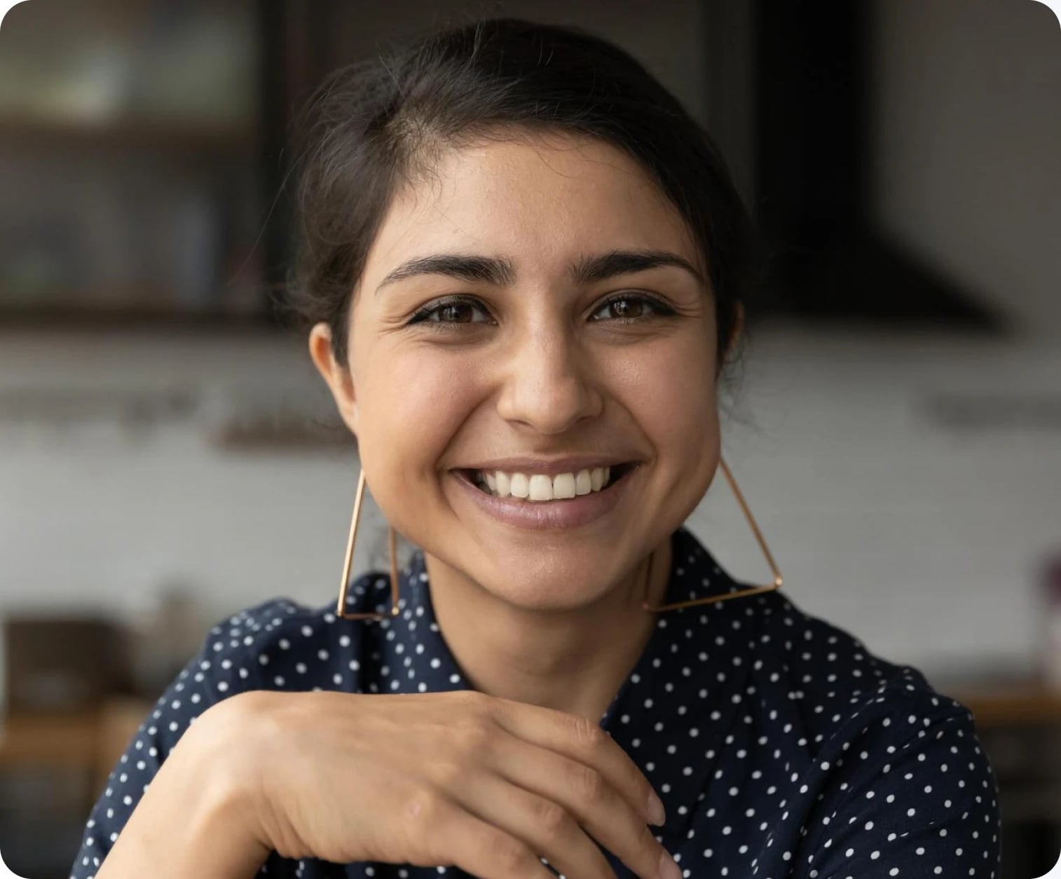 Customer smiling while watching an on-demand training session on her laptop