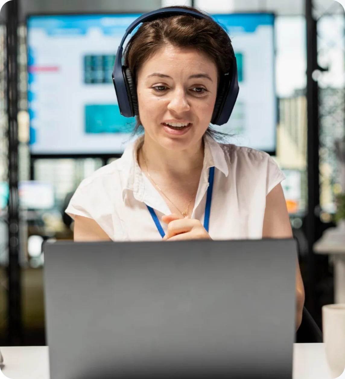 A presenter walking a prospect through the product live, headset on, in front of a dashboard screen