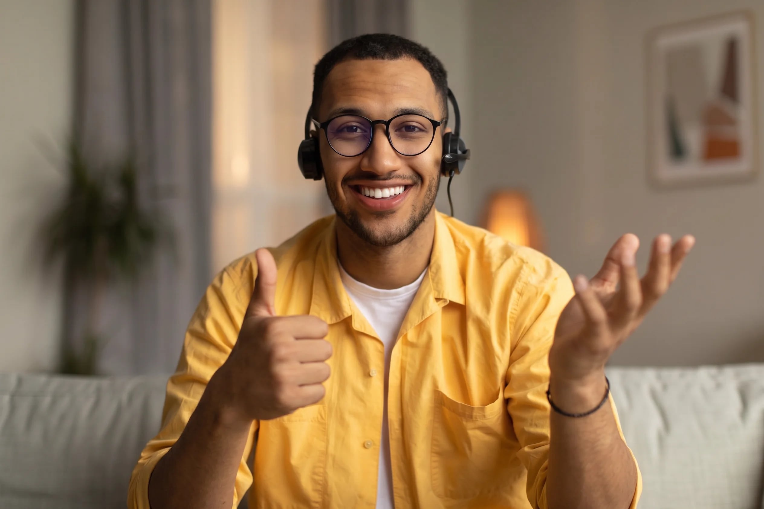Presenter speaking during a live webinar, with hands raised mid-explanation